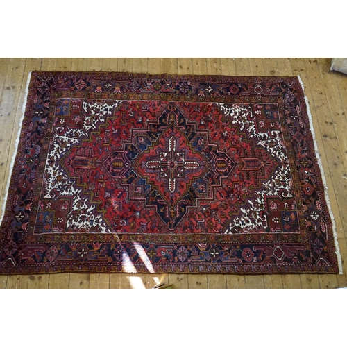 669 - A Red, Blue & White Central Medallion & Quartered Iranian Rug with an Olive Green Background. Measur... 