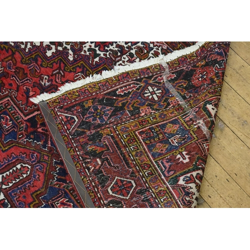 669 - A Red, Blue & White Central Medallion & Quartered Iranian Rug with an Olive Green Background. Measur... 