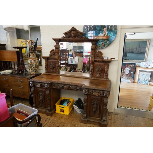 640 - A Victorian Heavily Carved Oak Revival Style Sideboard decorated with Game, Birds, a Carved Lion Mas... 