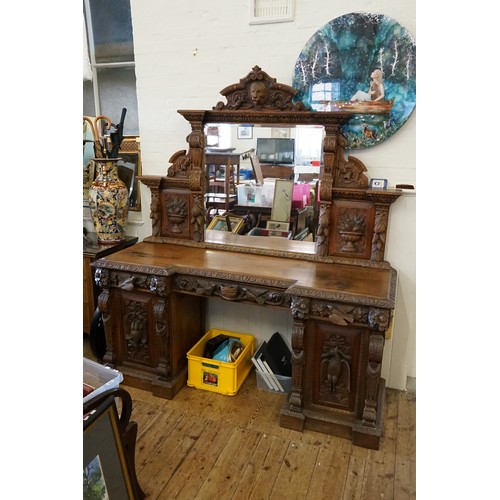 640 - A Victorian Heavily Carved Oak Revival Style Sideboard decorated with Game, Birds, a Carved Lion Mas... 