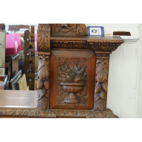 640 - A Victorian Heavily Carved Oak Revival Style Sideboard decorated with Game, Birds, a Carved Lion Mas... 