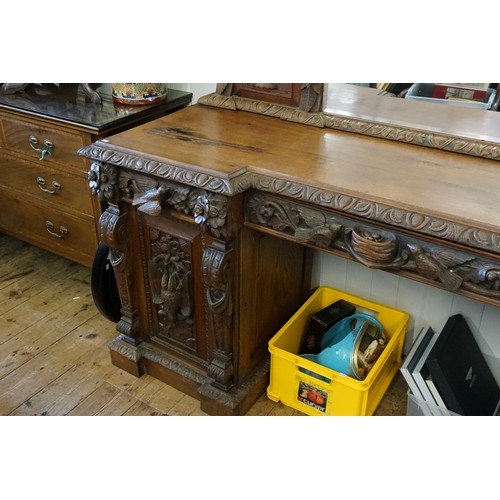 640 - A Victorian Heavily Carved Oak Revival Style Sideboard decorated with Game, Birds, a Carved Lion Mas... 