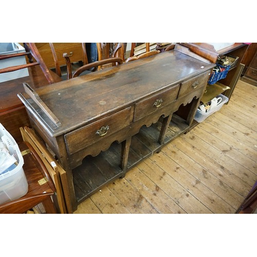 595 - An Antique Oak Three Drawers Dresser Base with Boarded Under Tier and Open Back, Resting on Square L... 