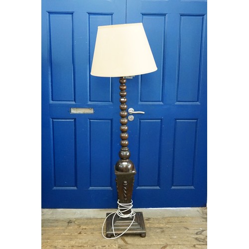 671 - An Italian design Turned & Carved Wood Standard Lamp on a pedestal base.