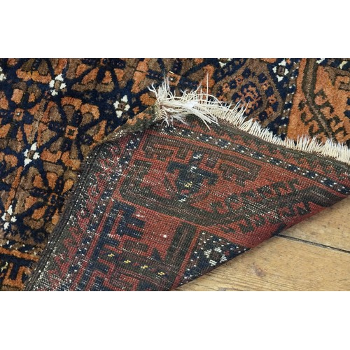 663 - A Red Ground Blue & White Fleck Greek Key Bordered Gul Pattern Carpet with fringe. Measuring: 1.2 me... 