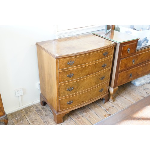 601 - A Reproduction Walnut Veneered Bow Fronted Chest fitted with four graduated Drawers & Resting on Bra... 