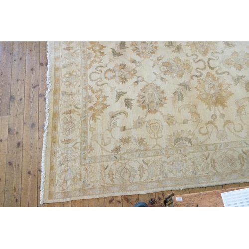 655A - A Large Cream & Beige Floral Pattern, Fringe Edged Rug. Measuring: 370cms x 270cms.