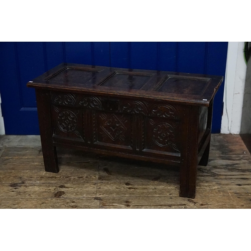 510 - An Antique Oak Three Panelled Coffer with a Floriette Carved Front resting on square feet with a fit... 