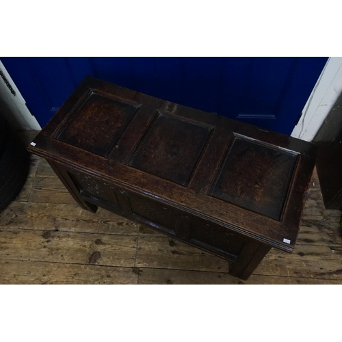 510 - An Antique Oak Three Panelled Coffer with a Floriette Carved Front resting on square feet with a fit... 