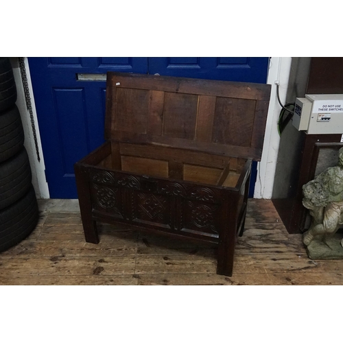 510 - An Antique Oak Three Panelled Coffer with a Floriette Carved Front resting on square feet with a fit... 