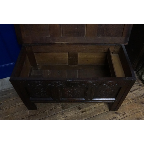 510 - An Antique Oak Three Panelled Coffer with a Floriette Carved Front resting on square feet with a fit... 