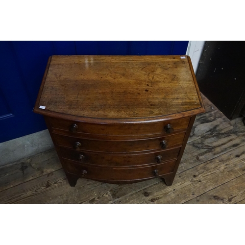 519 - A Mahogany Bow Fronted Chest of Four Graduated Drawers with turn wood handles & resting on bracket f... 