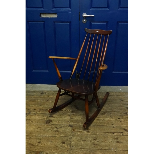 529 - A Yew Seated & stained as Beech Splat Back Rocking Chair with shaped cresting rail.