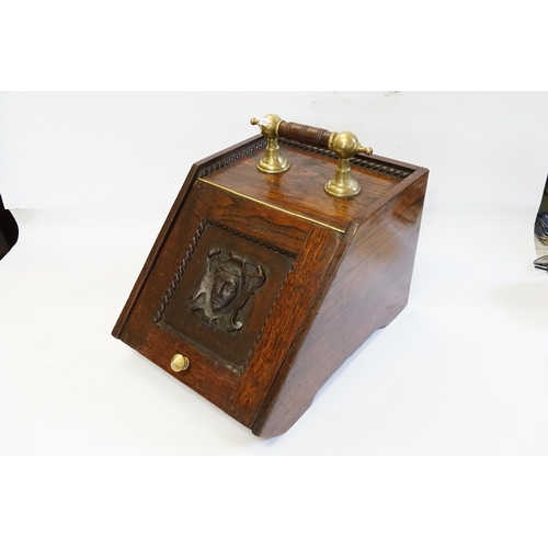 545 - A Late 19th Century Oak Brass mounted Coal Box decorated with a Carved Classical Face.