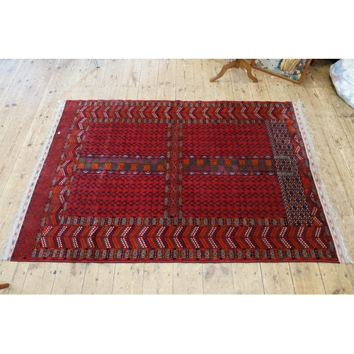 554 - A Red Ground Triple Bordered Sawtooth pattern Greek Key & Horseshoe quartered Carpet. Measuring: 201... 