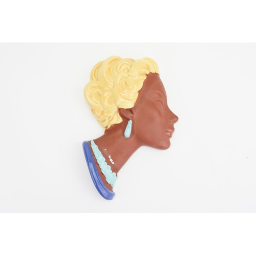 400 - A West German made Pottery Female Face Plaque in Terracotta, Blue & Yellow Highlights. Measuring: 27... 