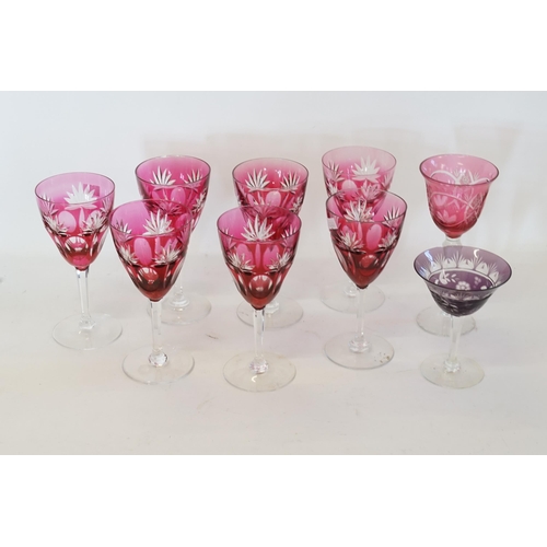 667 - A Set of 7 Ruby Tinted Hock Glasses resting on faceted Stems along with two others.