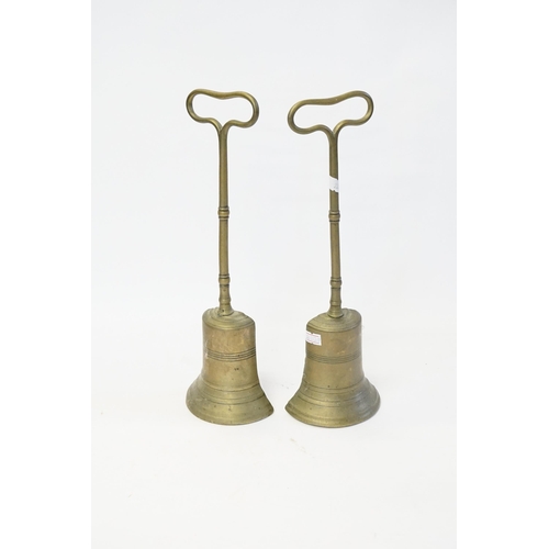 578 - A Pair of Antique Brass Bell Shaped Door Stops with Lead infill. Measuring: 33cms high.