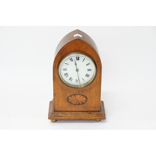 242 - An Oak Cased Mantle Clock with a Shell inlay, enamelled Face, Roman Numerals & a French movement.