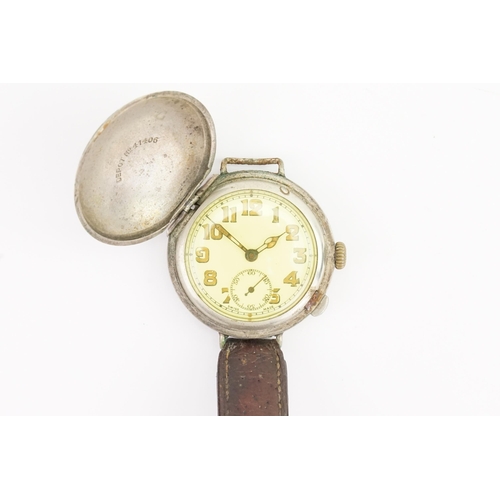 311 - A World War I 1920s Trench Watch with a Stainless Steel Face Covering on a Brown Leather Strap. Watc... 