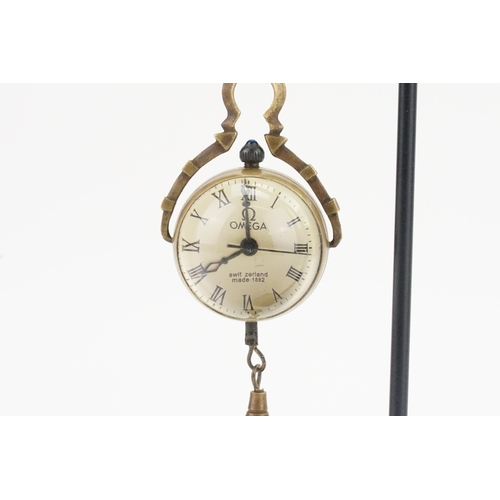 207 - A ladies 1882 marked Omega pendant globe watch with blue cabochon winder and visible mechanism, appr... 