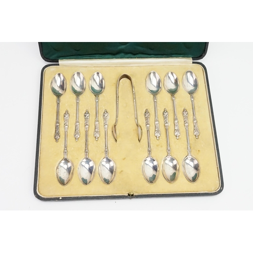 26 - A Set of 12 Silver Apostle Topped Tea Spoons & Tongs in Original Case.