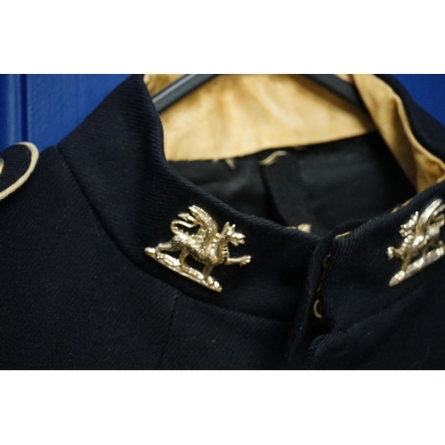 285 - A Navy Blue & White Trimmed Mess Jacket with Yellow Rope Sash, Lyre & Oakleaf Crest along with Match... 