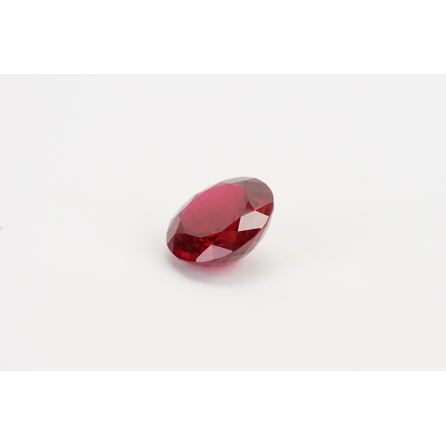 73 - A large round cut red synthetic Topaz. Weight 10.45g. 52.32ct.