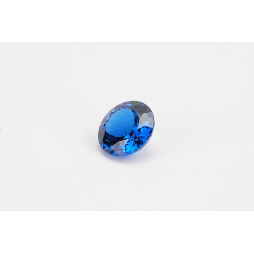 74 - A blue round cut synthetic Topaz 39.29ct. Weight 7.9g.