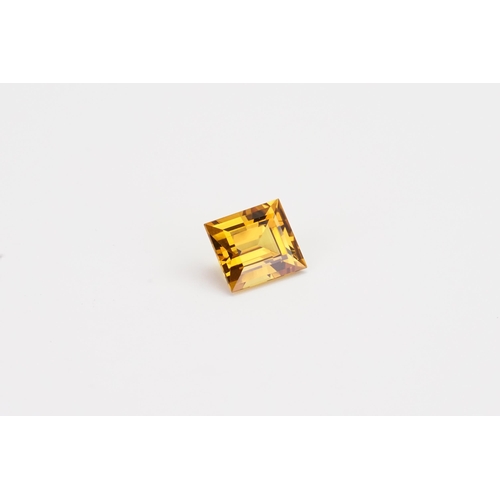 76 - An orange rectangle cut synthetic Sapphire. 13.2ct. Weight 2.6g.