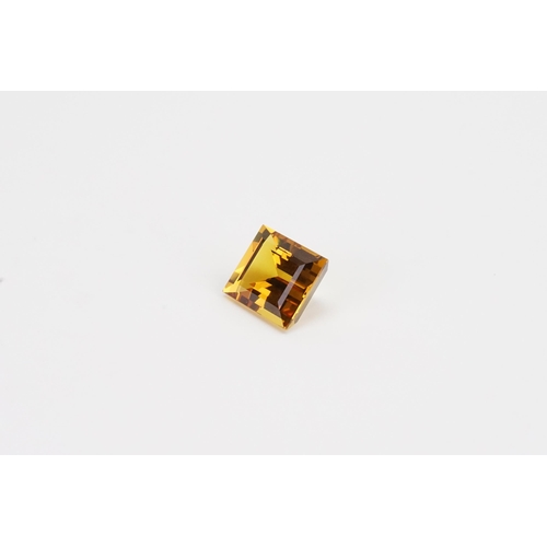 76 - An orange rectangle cut synthetic Sapphire. 13.2ct. Weight 2.6g.