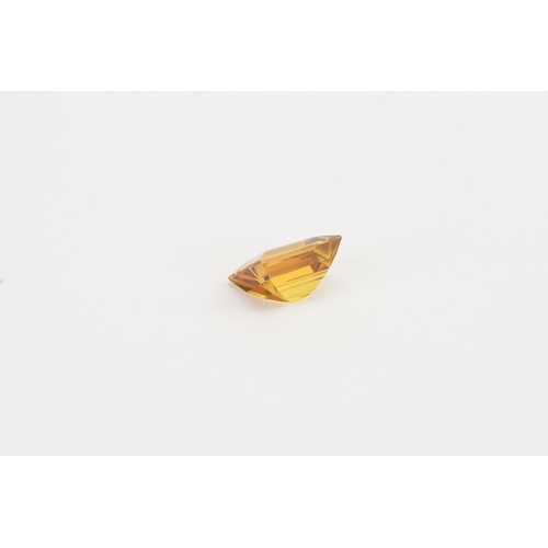 76 - An orange rectangle cut synthetic Sapphire. 13.2ct. Weight 2.6g.