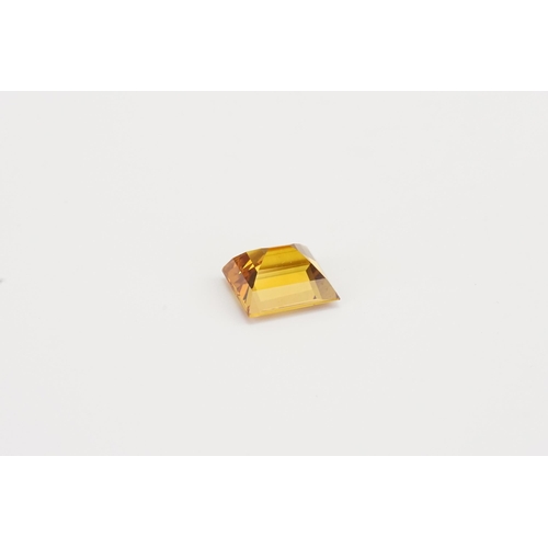 76 - An orange rectangle cut synthetic Sapphire. 13.2ct. Weight 2.6g.