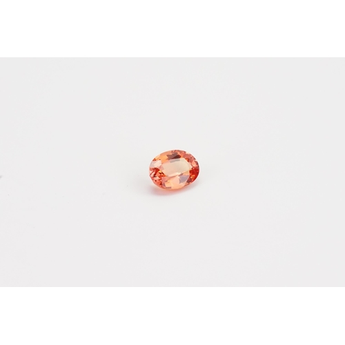 77 - An orange oval cut synthetic Sapphire 7.45ct. Weight 1.49ct.