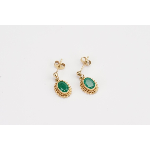 82 - A 9ct Gold pair of ladies Emerald earrings in the drop design. Weight 1.6g. 0.7ct size.