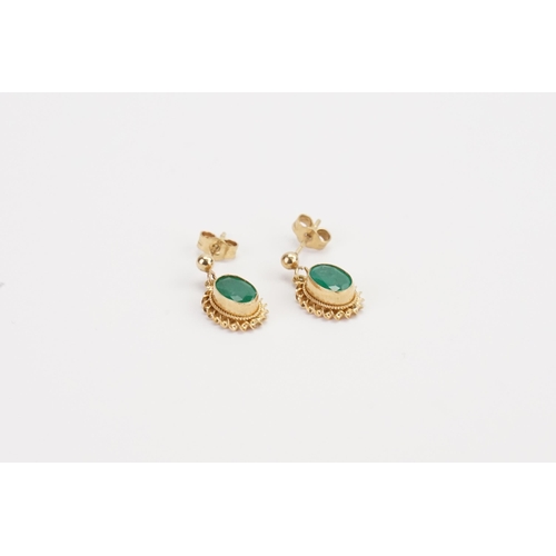 82 - A 9ct Gold pair of ladies Emerald earrings in the drop design. Weight 1.6g. 0.7ct size.