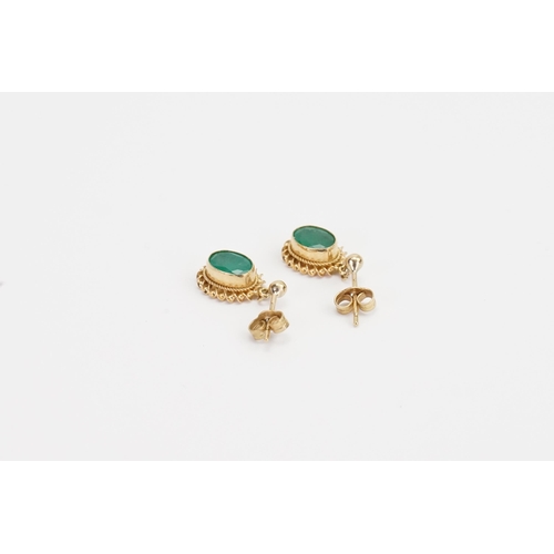 82 - A 9ct Gold pair of ladies Emerald earrings in the drop design. Weight 1.6g. 0.7ct size.