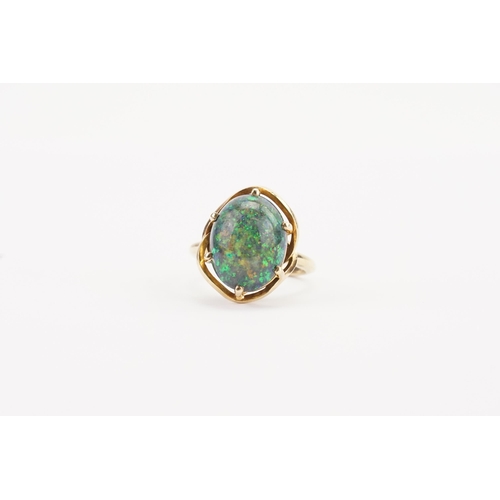 108 - A large oval Opal set ring, set in a mount that tests higher than 18ct gold. Diameter 15mm x 12mm. W... 