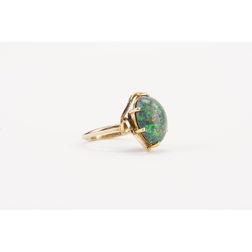 108 - A large oval Opal set ring, set in a mount that tests higher than 18ct gold. Diameter 15mm x 12mm. W... 