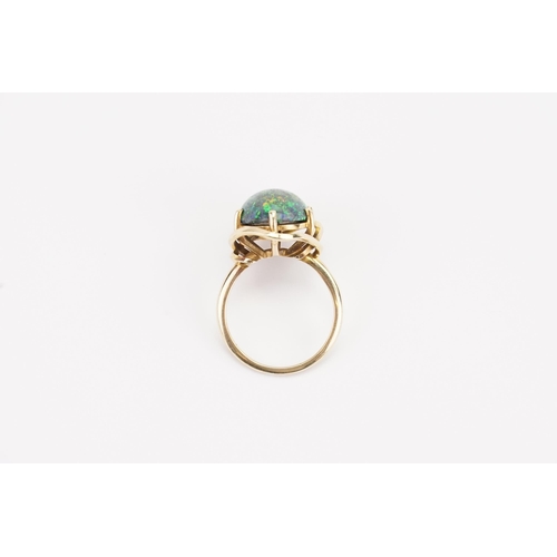 108 - A large oval Opal set ring, set in a mount that tests higher than 18ct gold. Diameter 15mm x 12mm. W... 