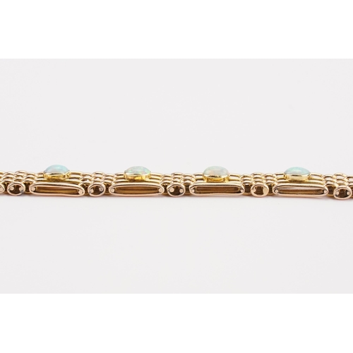 124 - A 15ct Gold gate bracelet set with 10 Opals. Length 18cm. Weight 18.6g.