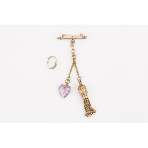 138 - A Gold coloured Amethyst heart set brooch, hung with tassel decoration, along with a diamond set cli... 