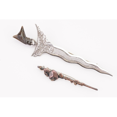 141 - An interesting carved top dagger brooch, along with a silver & brass brooch.