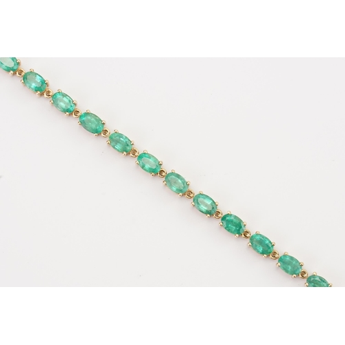 148 - A 9ct Gold Emerald set tennis bracelet. Set with 22 oval cut Emeralds. Each stone 3.9mm x 6mm. Lengt... 