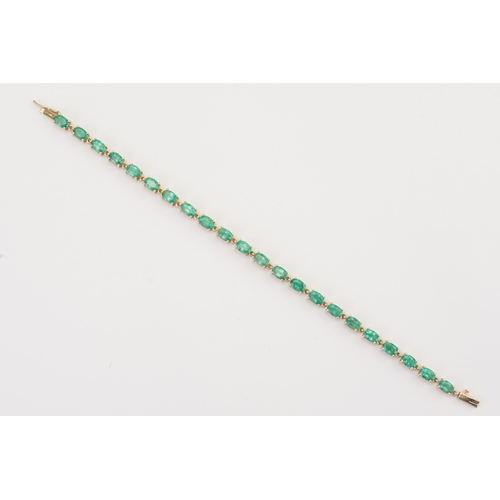 148 - A 9ct Gold Emerald set tennis bracelet. Set with 22 oval cut Emeralds. Each stone 3.9mm x 6mm. Lengt... 