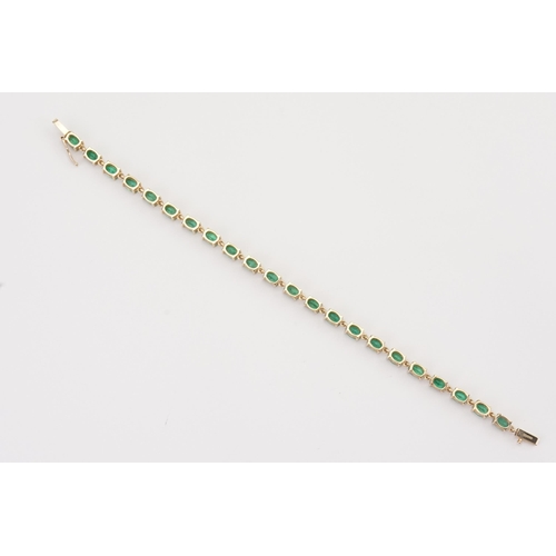 148 - A 9ct Gold Emerald set tennis bracelet. Set with 22 oval cut Emeralds. Each stone 3.9mm x 6mm. Lengt... 