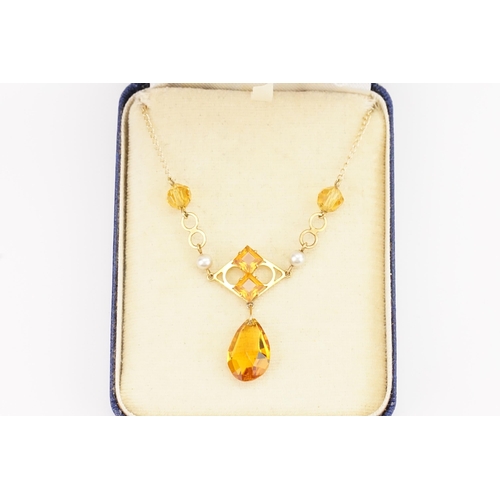 159 - A 9ct Gold orange stone set necklace. Set with orange tear drop stones. Weight 4.3g.