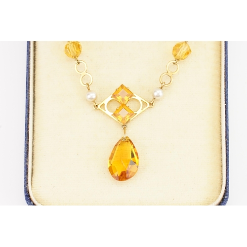 159 - A 9ct Gold orange stone set necklace. Set with orange tear drop stones. Weight 4.3g.