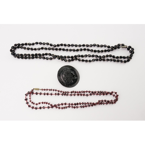 171 - A Jet Style Glass Long Beed Necklace, a Garnet Necklace & a Mourning Brooch depicting a Classical Ma... 