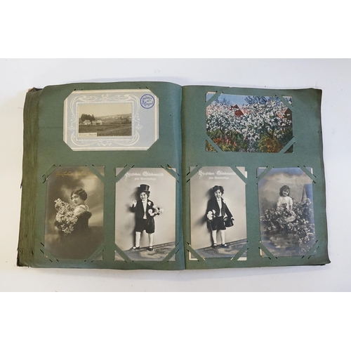 704 - An Album containing a selection of Post Cards & Silks to include a Biplane, River Scenes, Koln, Chro... 